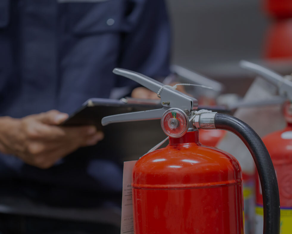 Engineer checking fire extinguisher