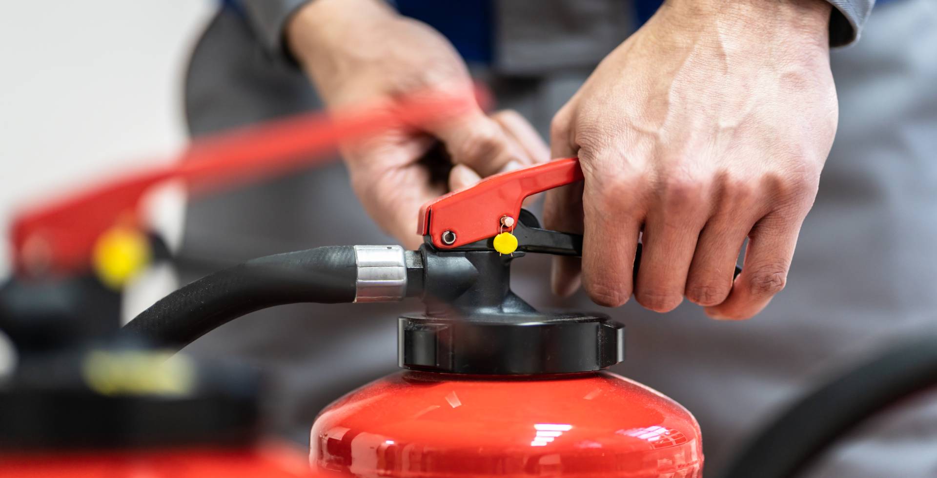 a person is opening the fire extinguishers